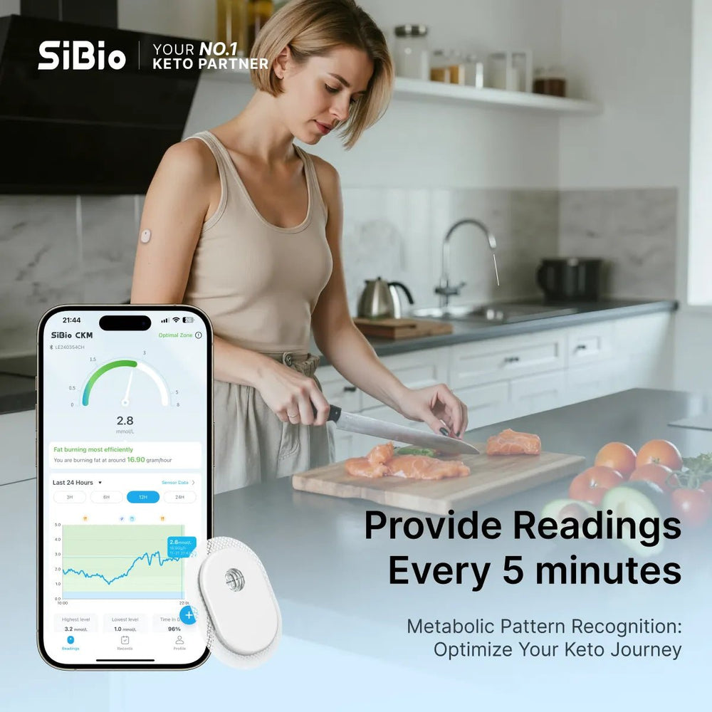 SiBio keto monitor app on phone shows ketone level . Woman in kitchen uses monitor, app provides readings every 5 mins.